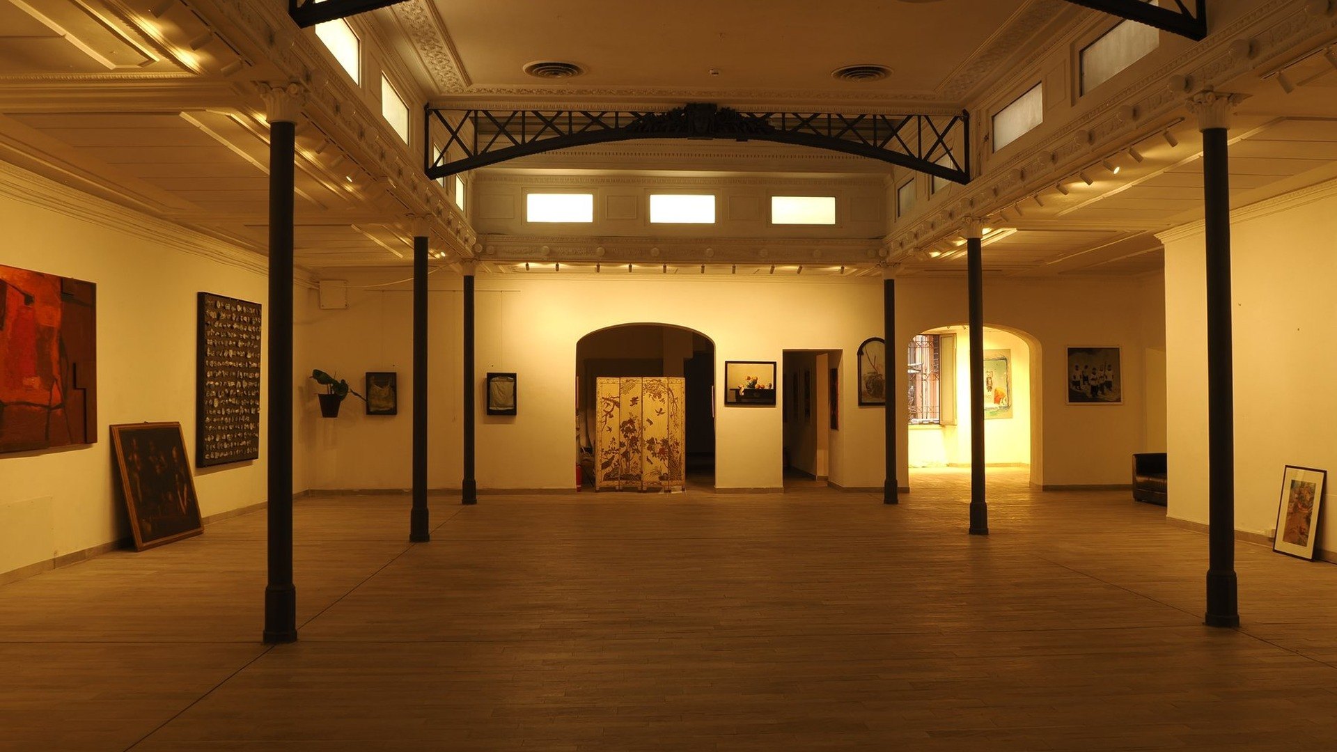Studio Liberty — the main hall with artworks on the walls and daylight from above, event space in central Rome